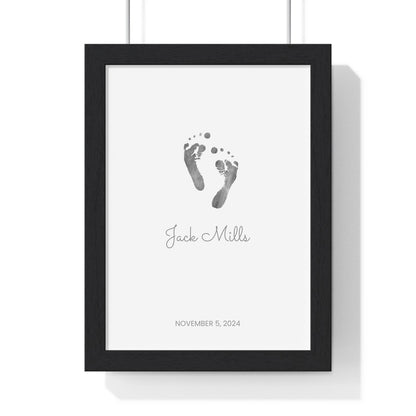 Framed keepsake print with baby footprints on a white background with black frame.
