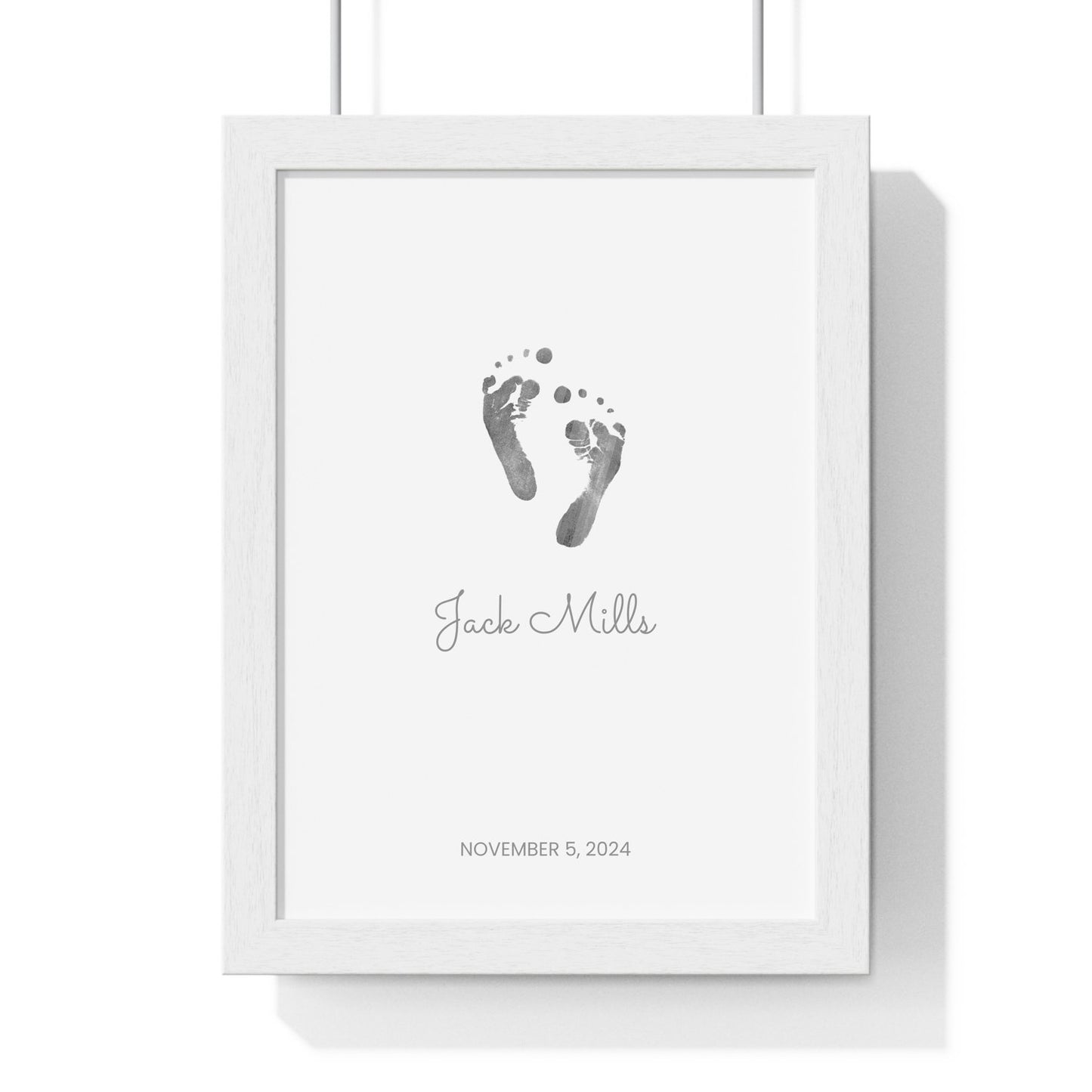 Framed keepsake print with baby footprints on a white background