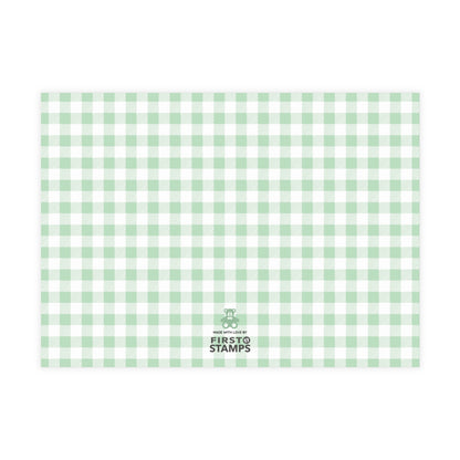 Green and white checkered paper with 'First Stamps' logo at the bottom right corner on a white background.