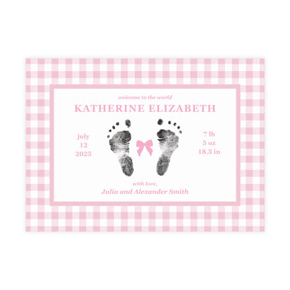 Baby birth announcement card with pink gingham border and footprints on a white background