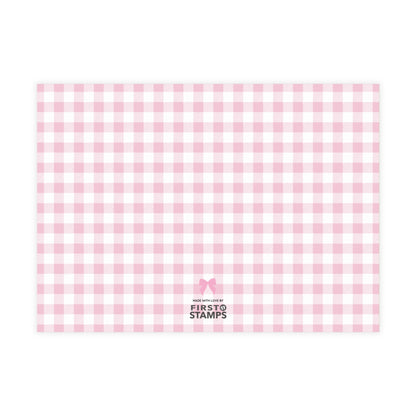 Pink and white checkered paper with 'First Stamps' logo at the bottom right corner on a white background.