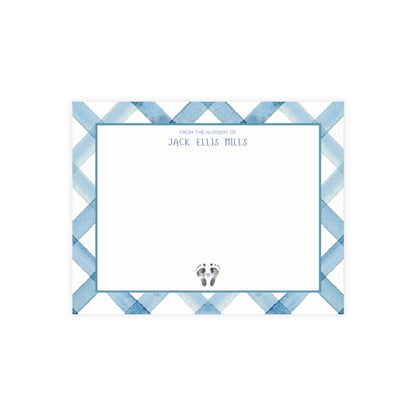 Note card with blue geometric pattern and baby footprints on a white background