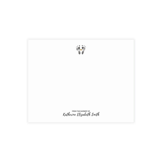 Note card with baby footprints and text 'From the nursery of Katherine Elizabeth Smith' on a white background