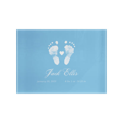 Blue acrylic block with white baby footprints and text