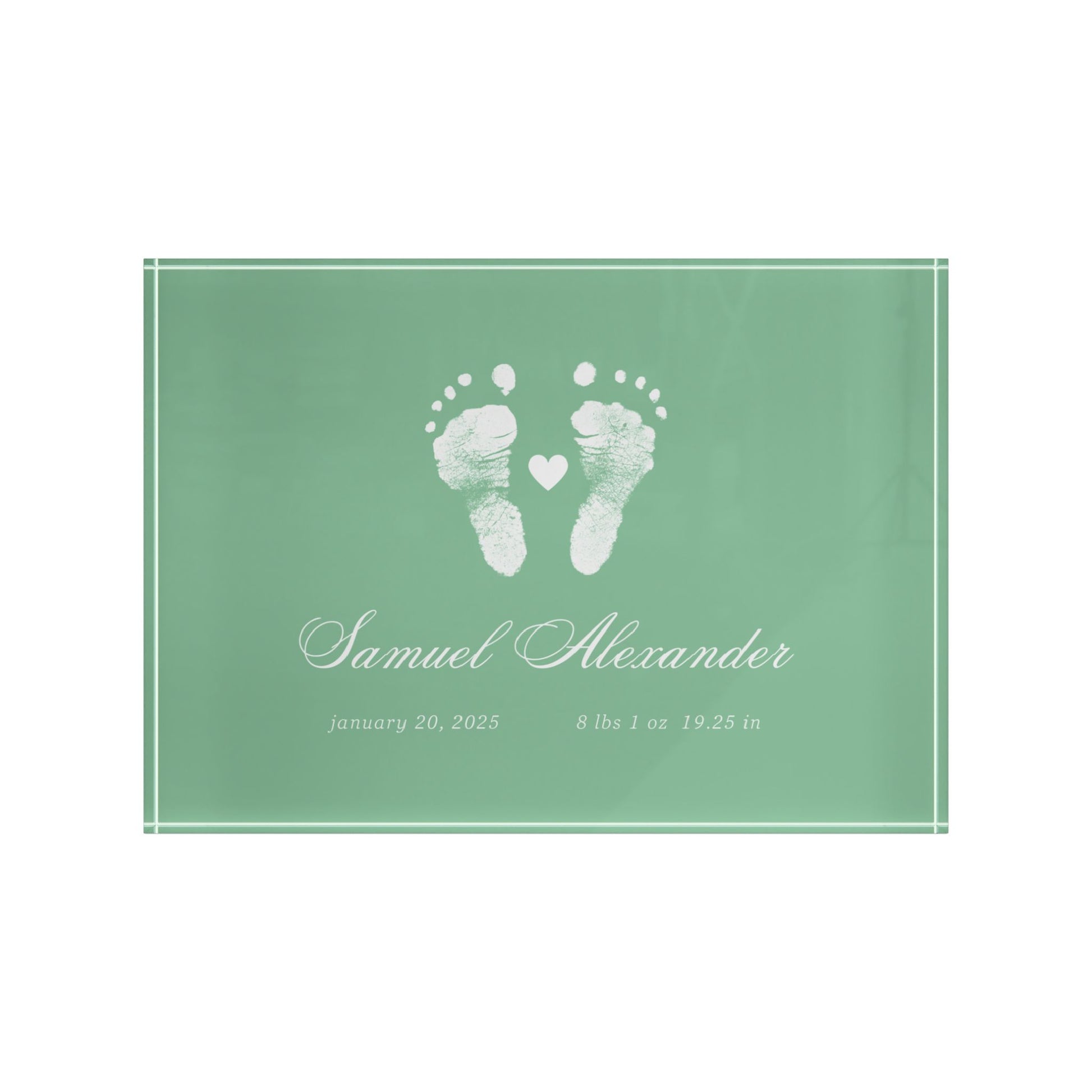 Green acrylic block with white baby footprints and text