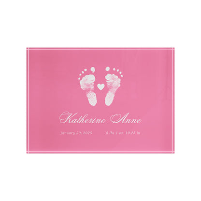 Pink acrylic block with white baby footprints and text