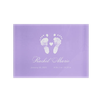 Purple acrylic block with white baby footprints and text.