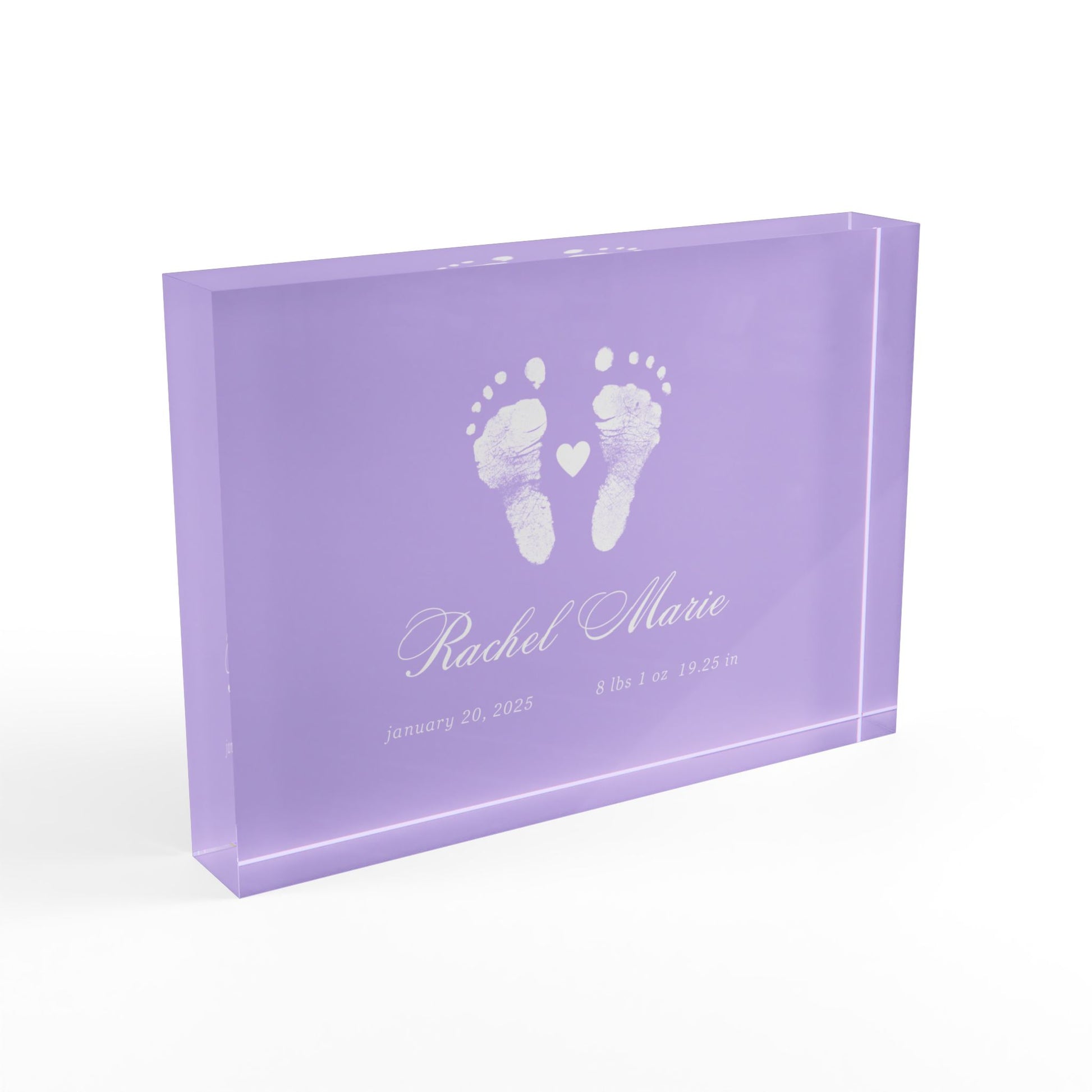 Purple acrylic block with white baby footprints and text._2