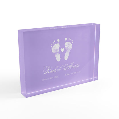 Purple acrylic block with white baby footprints and text._2