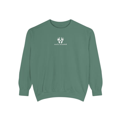 Light green sweatshirt with a baby footprint logo