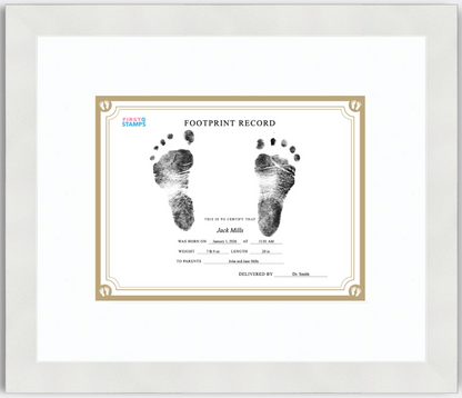 Framed baby footprint record with black and white footprints on a white background